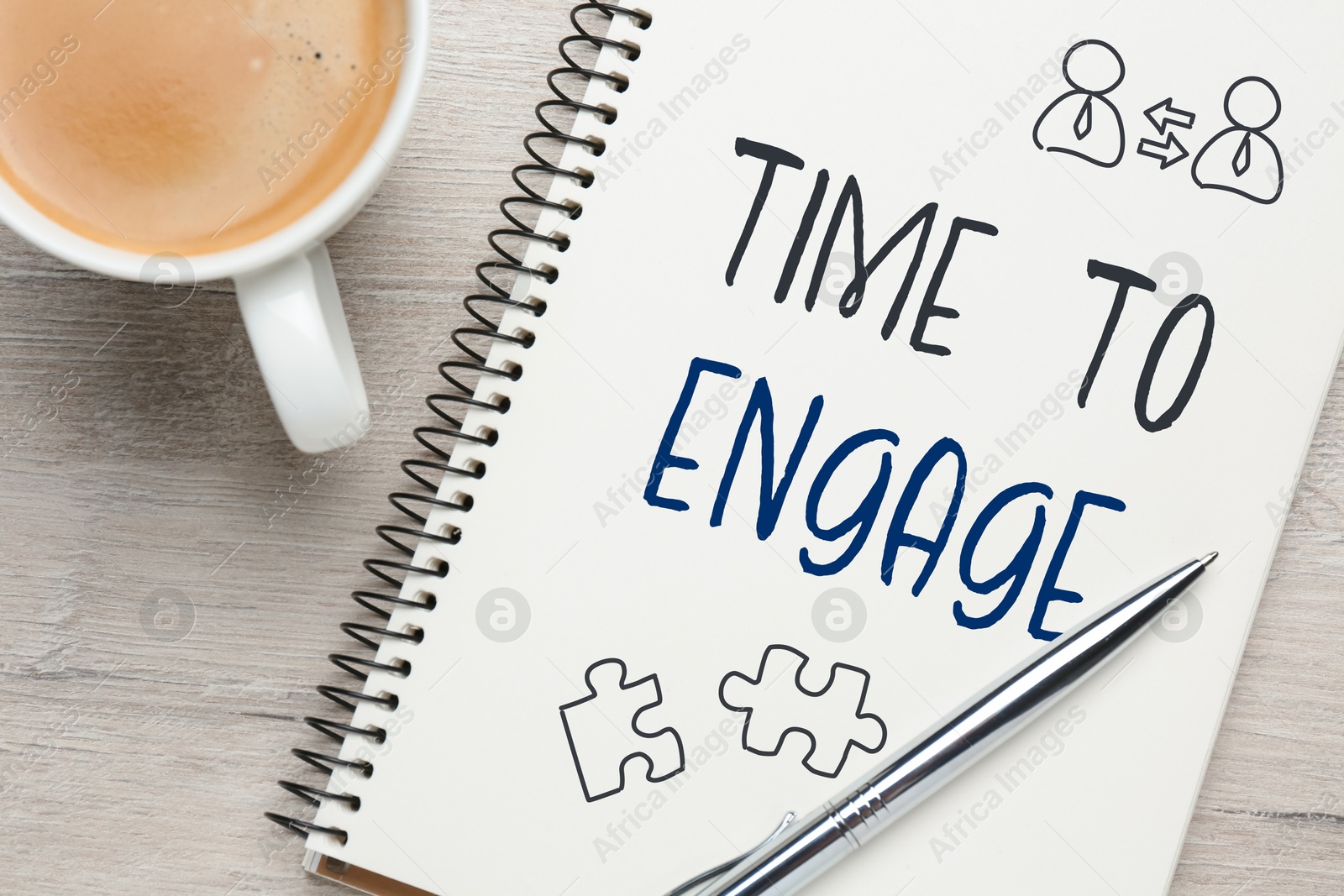 Time to engage. Words and drawings in notebook and coffee on wooden table, top view Image of Time to engage. Words and drawings in notebook and coffee on wooden table, top view