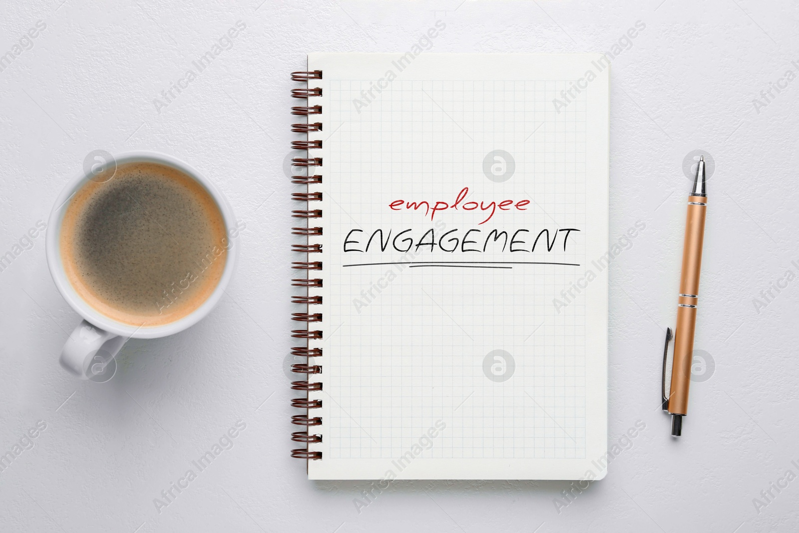Employee Engagement words written in notebook, pen and coffee on white background, top view Image of Employee Engagement words written in notebook, pen and coffee on white background, top view