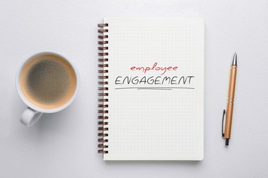 Image of Employee Engagement words written in notebook, pen and coffee on white background, top view