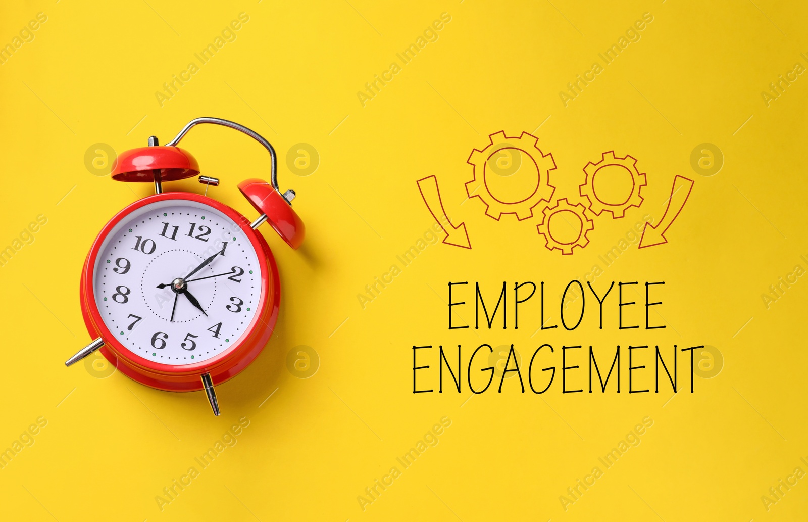 Employee engagement. Red alarm clock and words on yellow background, top view Image of Employee engagement. Red alarm clock and words on yellow background, top view