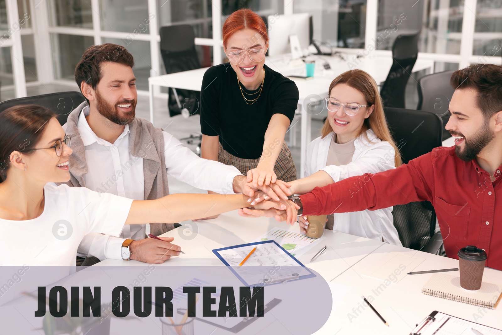 Join Our Team. Group of people joining hands at table in office. Employee search, recruitment concept Image of Join Our Team. Group of people joining hands at table in office. Employee search, recruitment concept