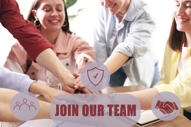 Image of Join Our Team. Group of people joining hands at table in office, closeup. Employee search, recruitment concept