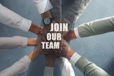 Image of Join Our Team. Group of people holding hands together at grey table, top view. Employee search, recruitment concept