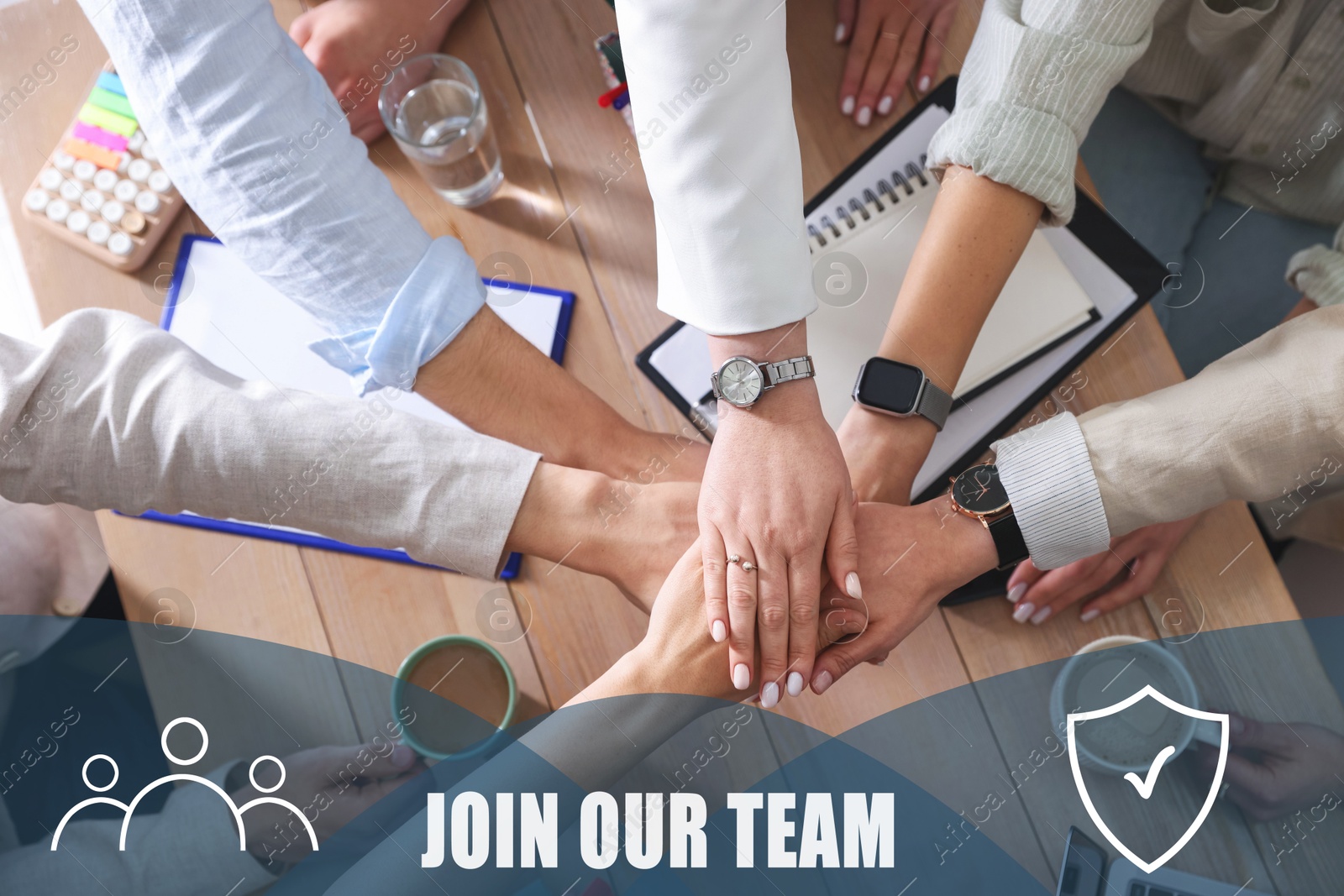 Image of Join Our Team. Group of people holding hands together at table indoors, closeup. Employee search, recruitment concept