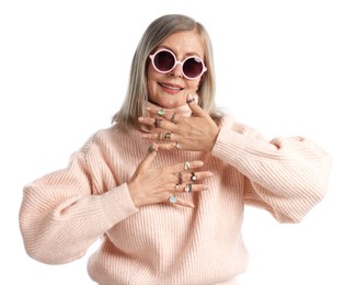 Photo of Senior woman wearing different rings on white background