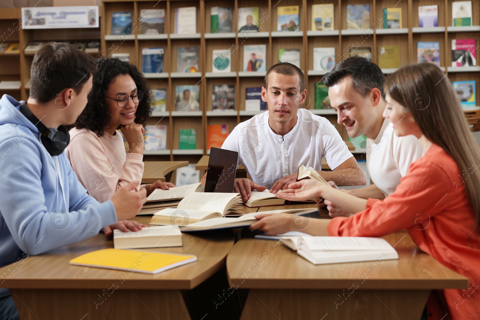 People studying together at desks in public library Photo of People studying together at desks in public library