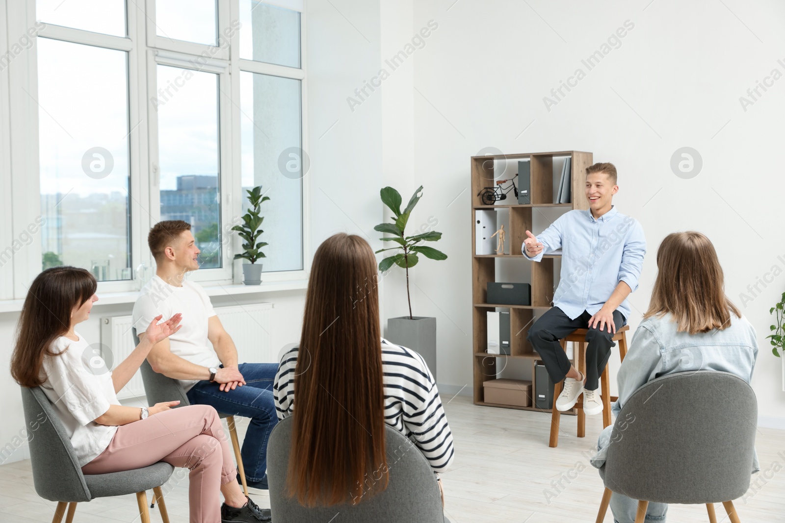 Photo of Group of people having meeting during life coaching class indoors