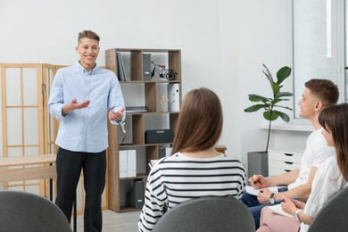 Photo of Group of people having meeting during life coaching class indoors