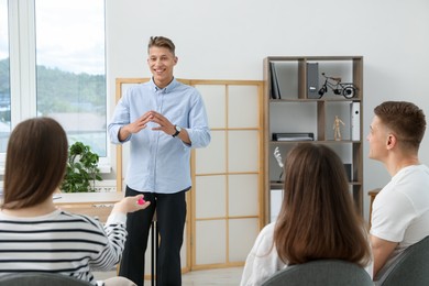 Photo of Group of people having meeting during life coaching class indoors