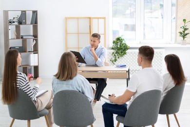 Photo of Group of people having meeting during life coaching class indoors