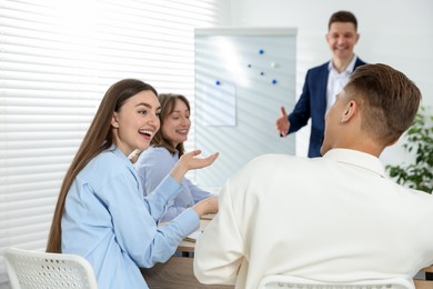Photo of Group of people having meeting during life coaching class indoors, selective focus