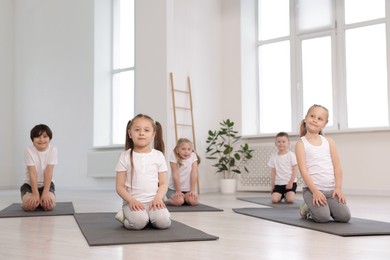 Photo of Group of children on yoga mats in class