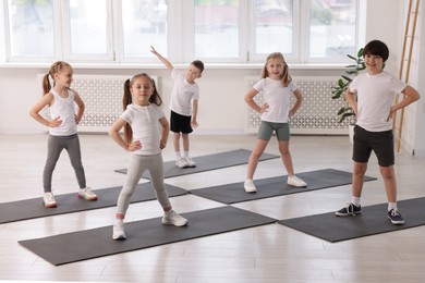 Photo of Group of children on yoga mats in class