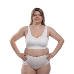 Photo of Weight loss. Plus size woman in underwear on white background