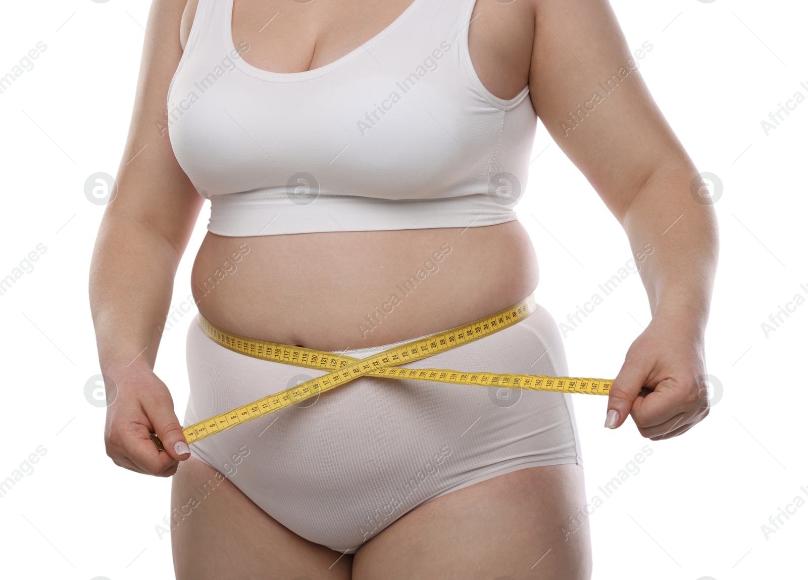 Weight loss. Plus size woman measuring waist with tape on white background, closeup Photo of Weight loss. Plus size woman measuring waist with tape on white background, closeup