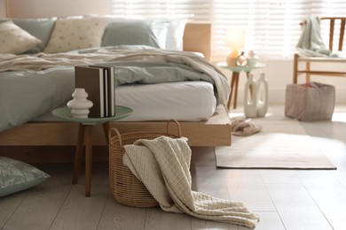 Photo of Comfortable bed with soft linens and decor in stylish room. Home textile