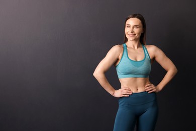 Photo of Portrait of professional trainer on black background. Space for text
