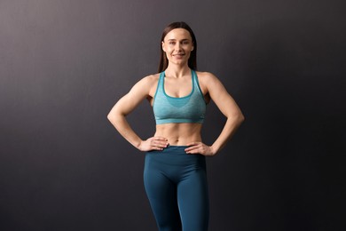 Photo of Portrait of professional trainer on black background