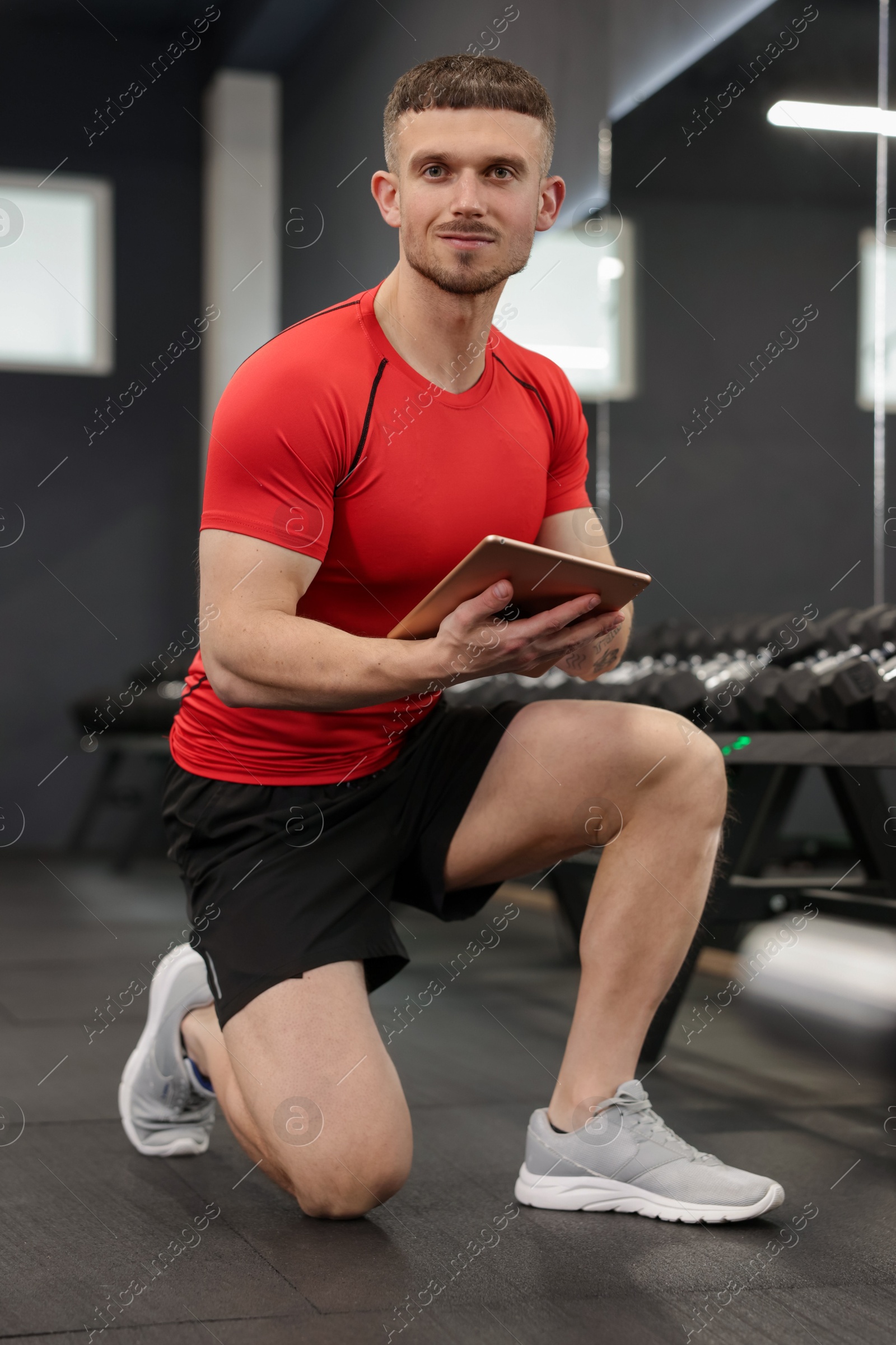 Personal trainer with tablet in sport center Photo of Personal trainer with tablet in sport center