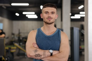 Photo of Portrait of professional personal trainer in gym