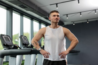 Photo of Portrait of professional personal trainer in sport center