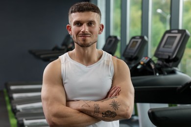 Photo of Portrait of professional personal trainer in sport center