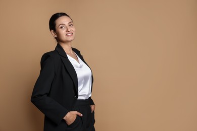Photo of Confident business woman in suit on beige background. Space for text