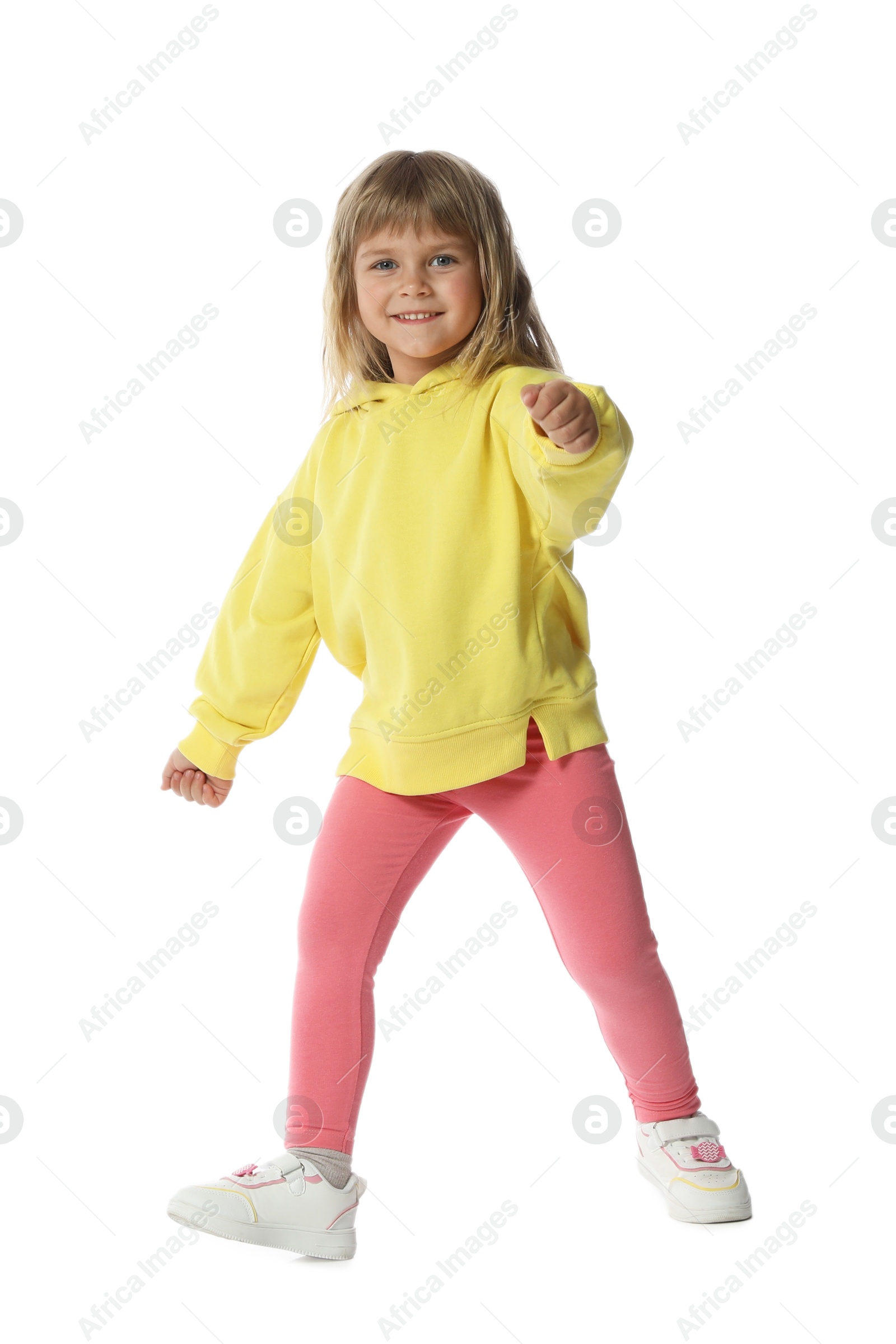 Happy little girl dancing on white background Photo of Happy little girl dancing on white background