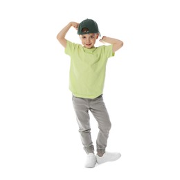 Photo of Happy little boy in baseball hat dancing on white background