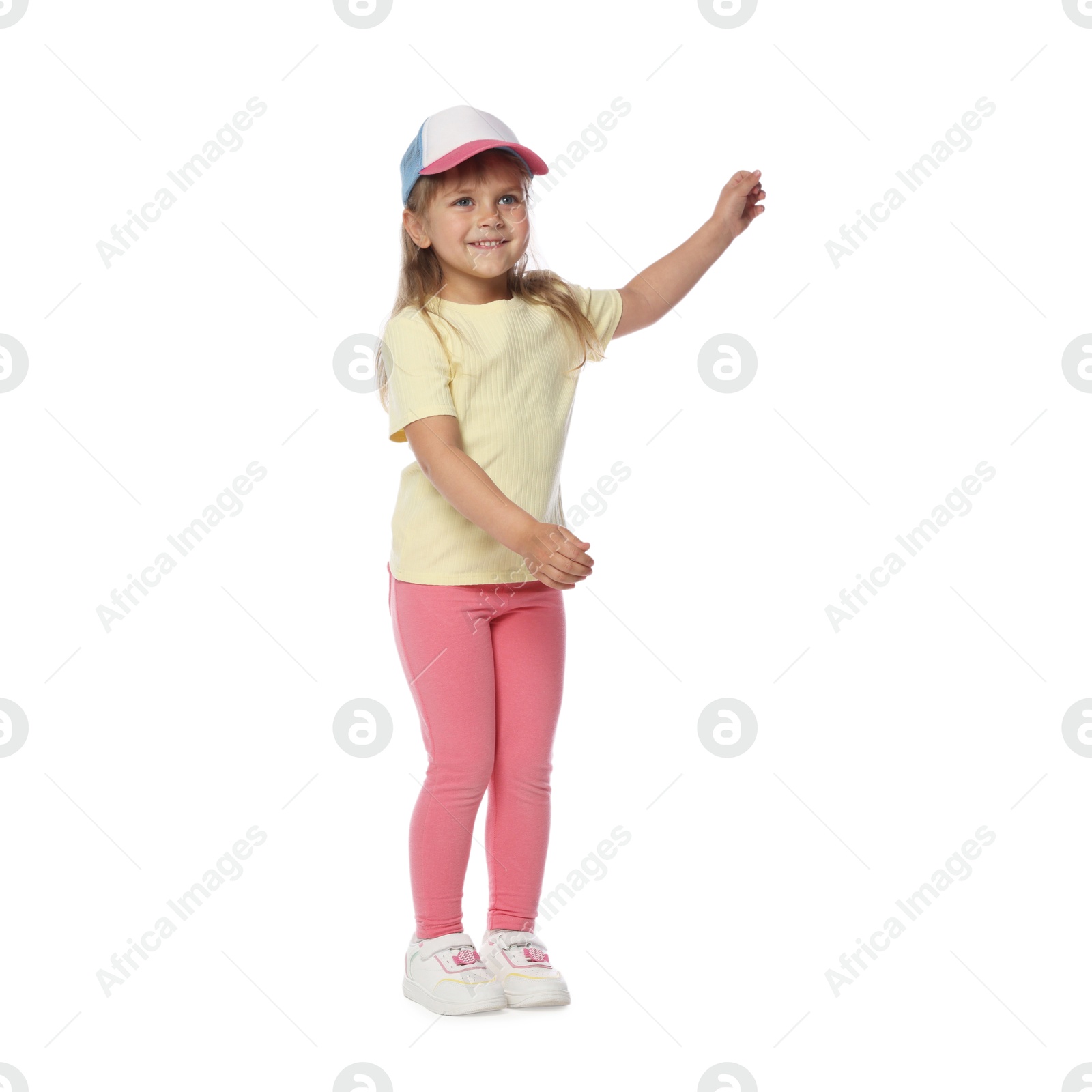 Happy little girl in baseball hat dancing on white background Photo of Happy little girl in baseball hat dancing on white background