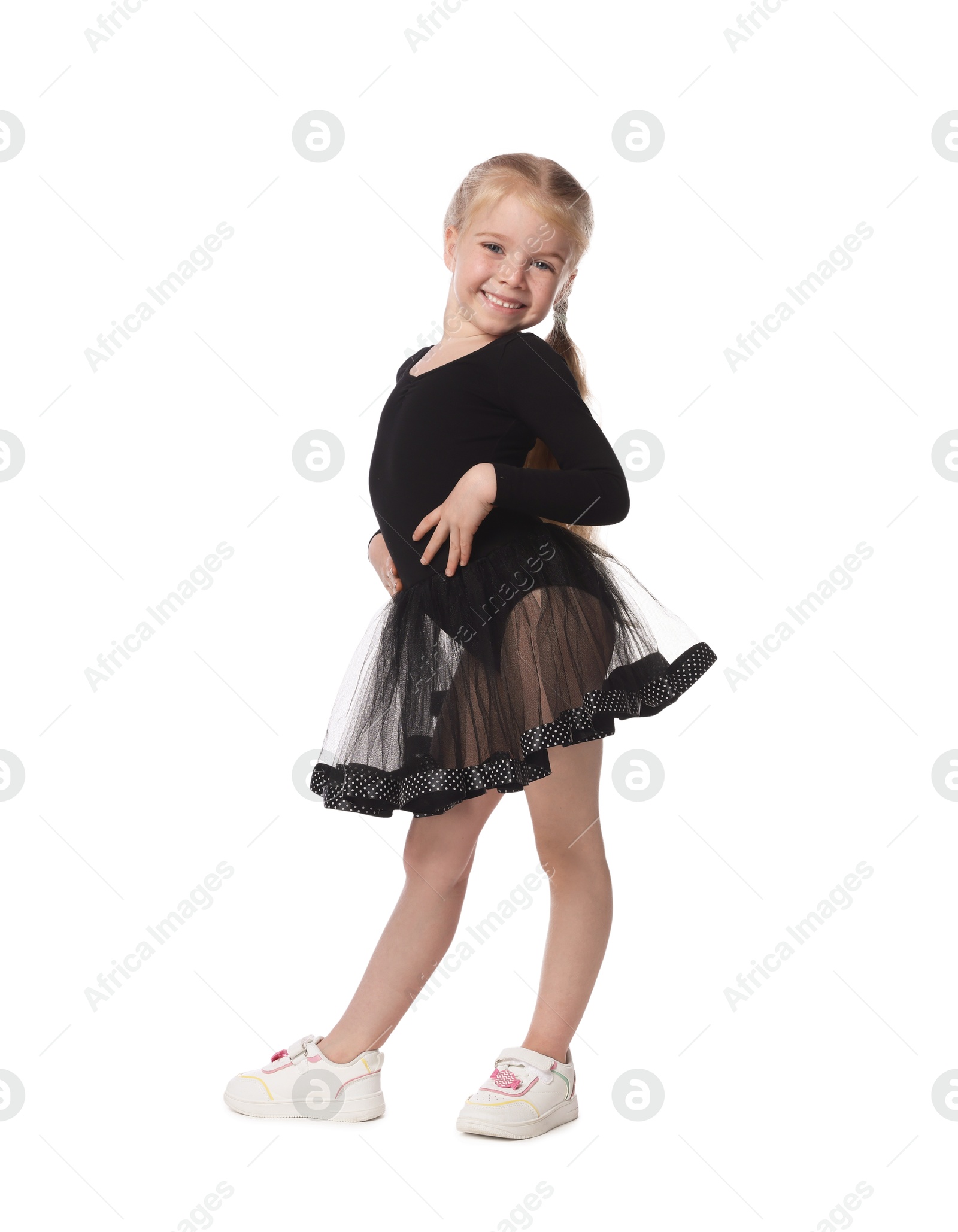 Cute little girl dancing on white background Photo of Cute little girl dancing on white background