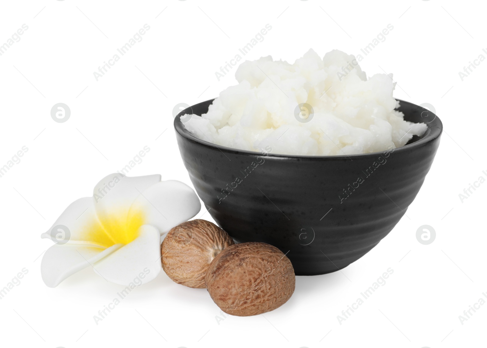 Natural shea butter in bowl, nuts and flower isolated on white Photo of Natural shea butter in bowl, nuts and flower isolated on white