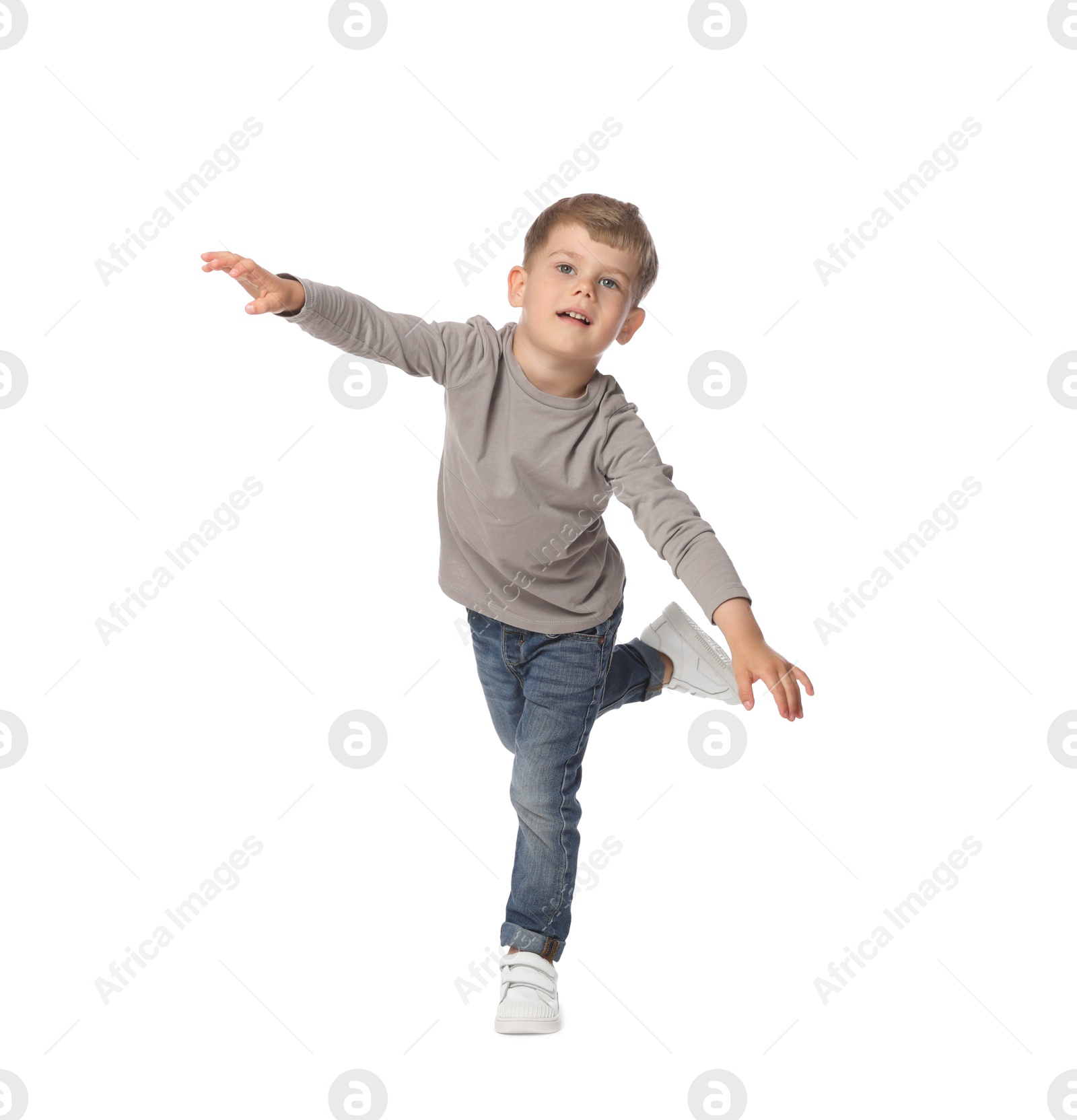 Happy little boy dancing on white background Photo of Happy little boy dancing on white background