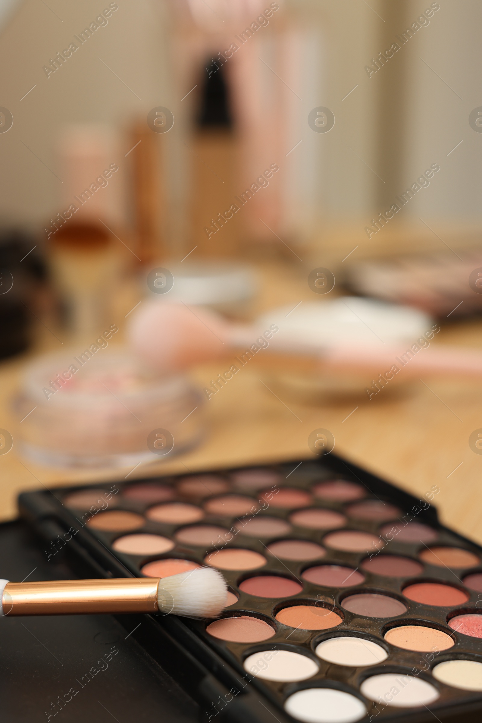 Eyeshadow palette and brush on wooden table, closeup Photo of Eyeshadow palette and brush on wooden table, closeup