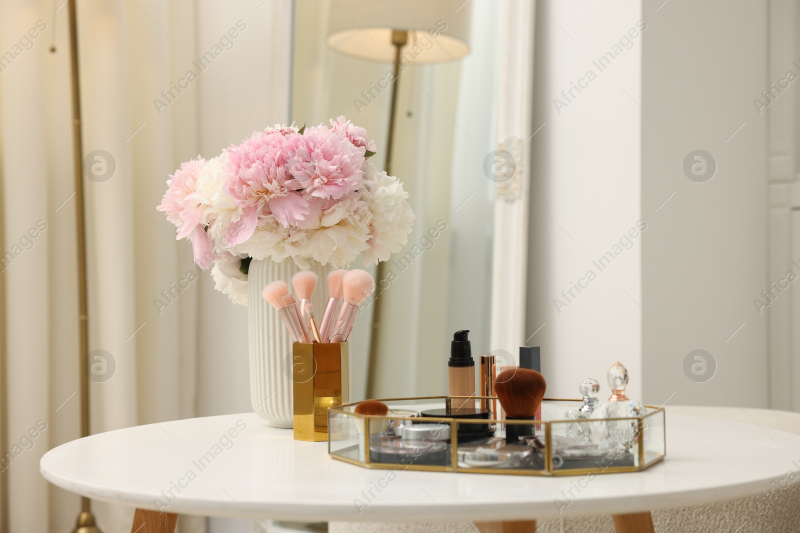 Tray with different makeup products on white table indoors. Space for text Photo of Tray with different makeup products on white table indoors. Space for text