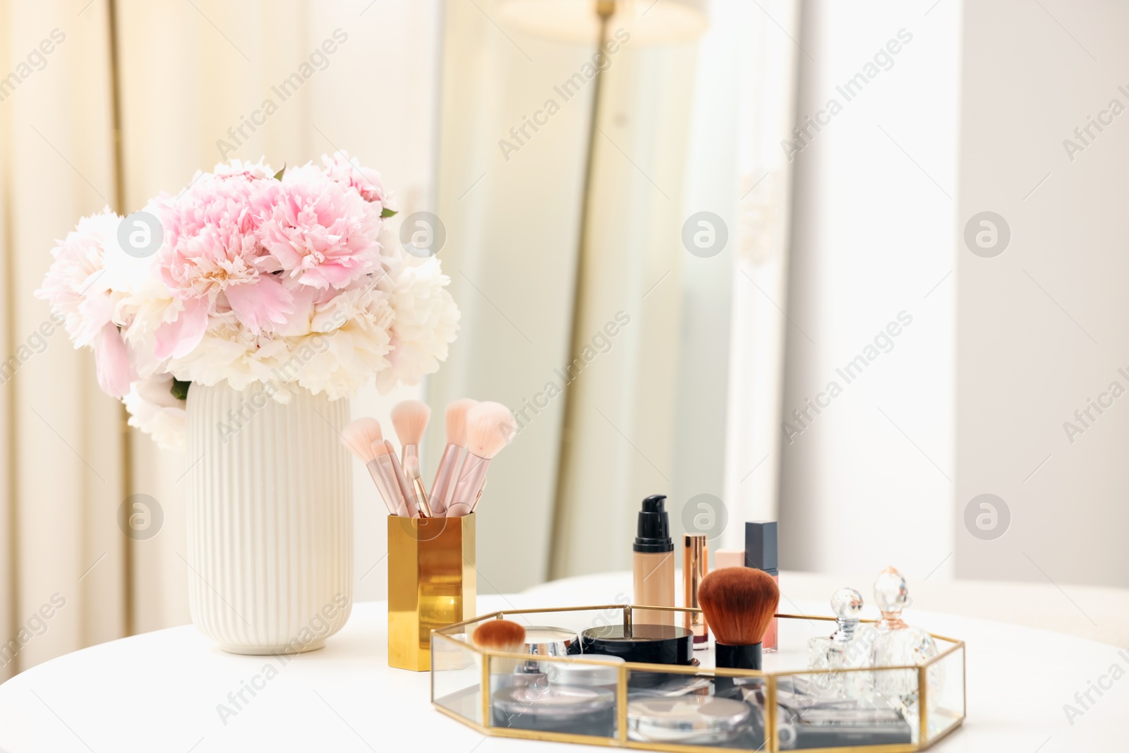 Tray with different makeup products on white table indoors. Space for text Photo of Tray with different makeup products on white table indoors. Space for text