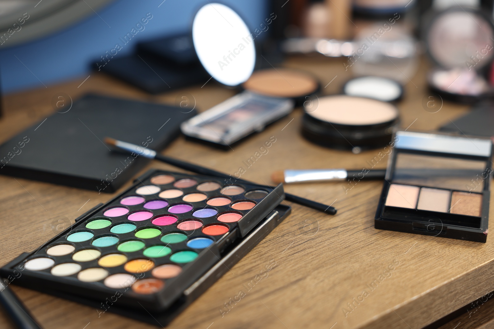 Different makeup products on wooden table indoors, closeup Photo of Different makeup products on wooden table indoors, closeup