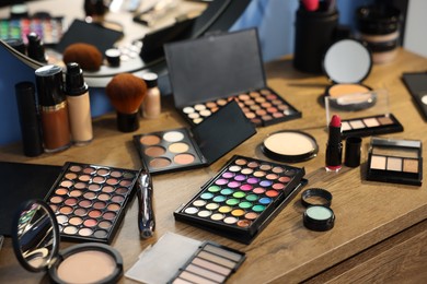 Photo of Different makeup products on vanity indoors, closeup