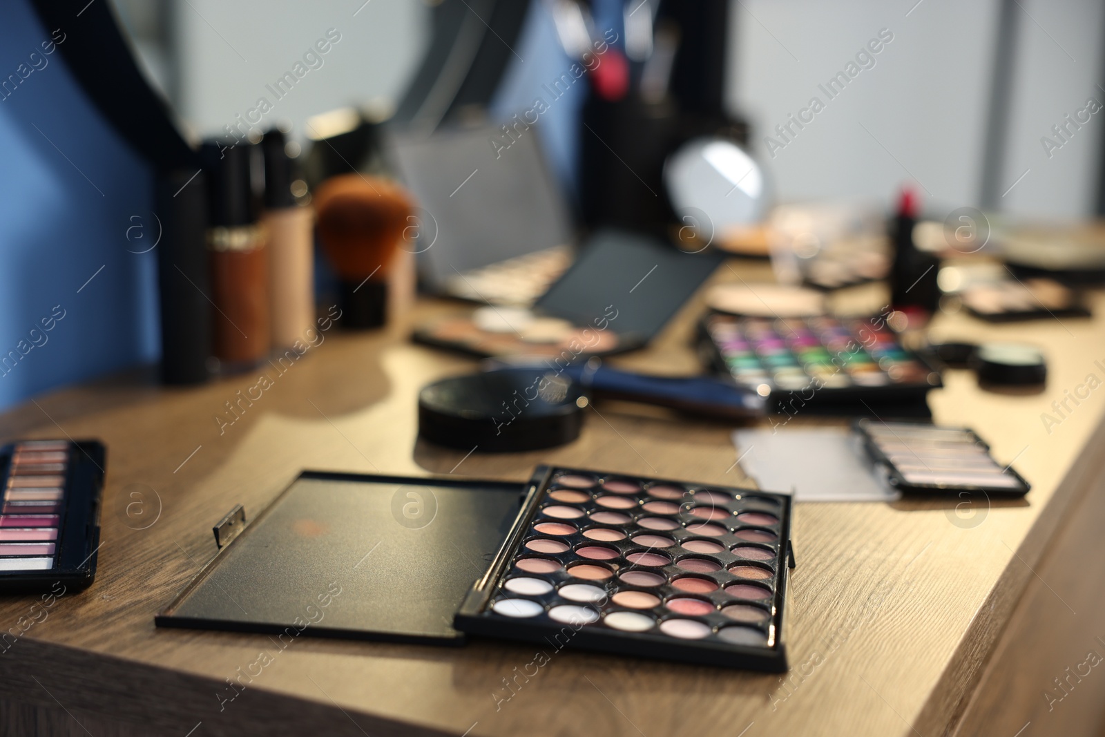 Different makeup products on wooden table indoors, closeup Photo of Different makeup products on wooden table indoors, closeup