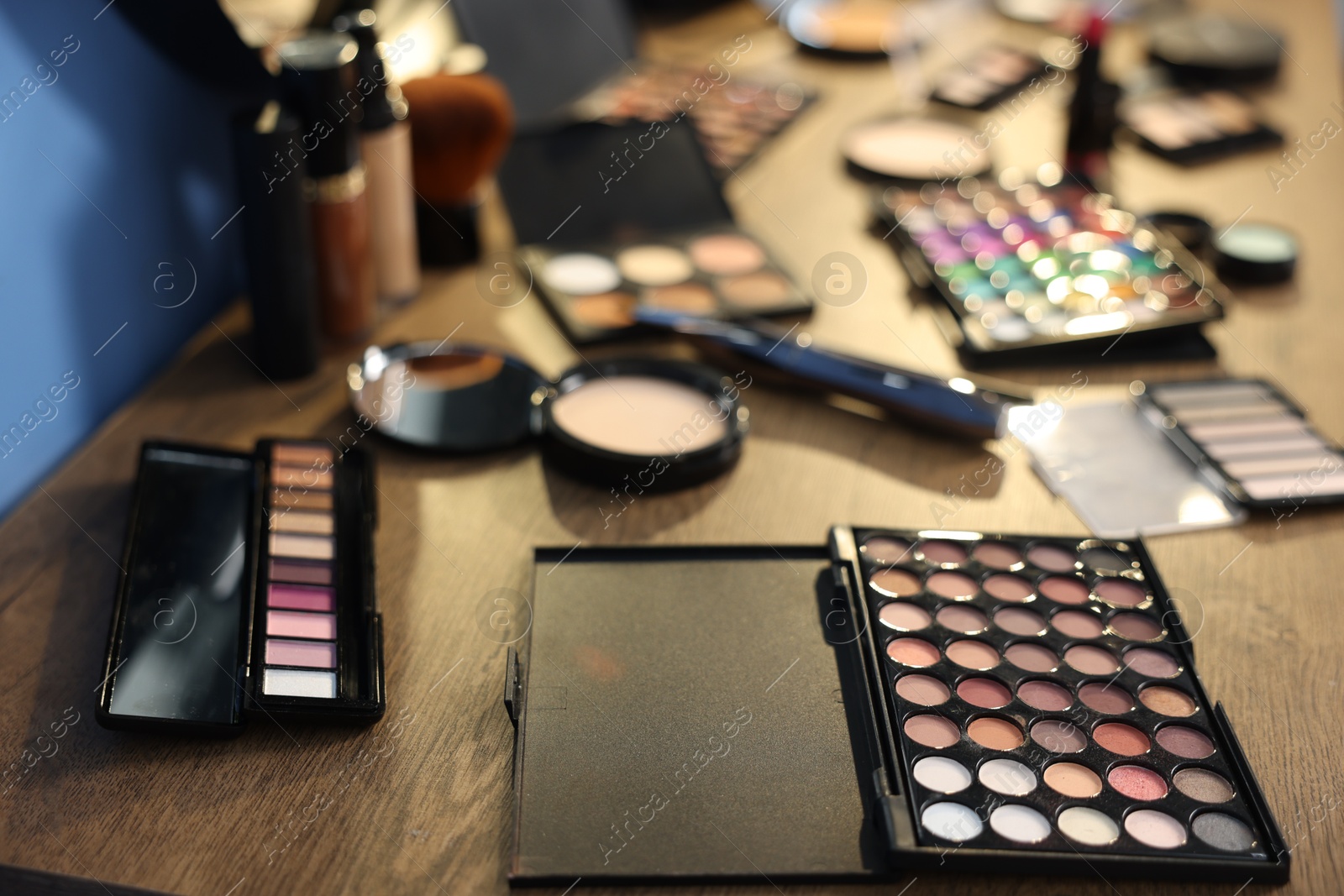 Different makeup products on wooden table, closeup Photo of Different makeup products on wooden table, closeup