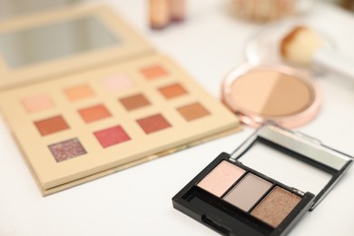 Photo of Different makeup products on white table, closeup