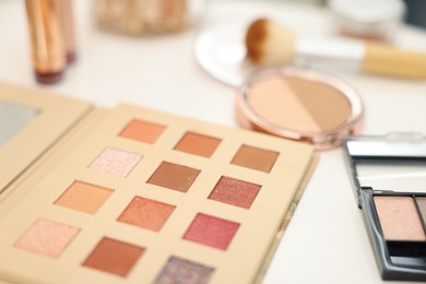 Photo of Different makeup products on white table, closeup