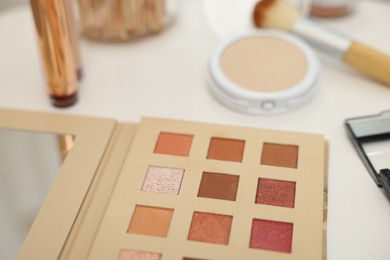 Photo of Different makeup products on white table, closeup