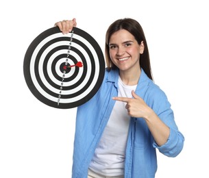 Photo of Targeting. Smiling woman pointing at dart board with arrow on white background