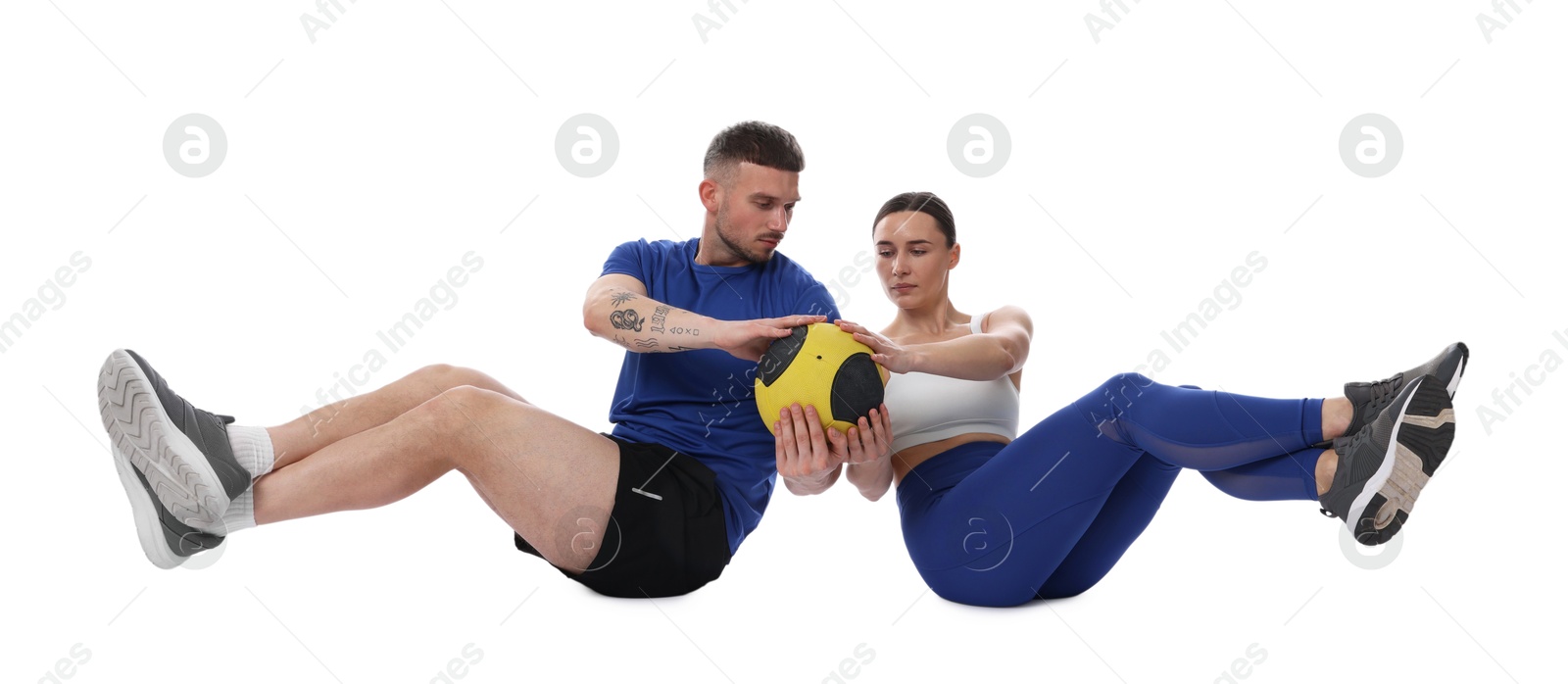 Woman and man exercising with medicine ball on white background Photo of Woman and man exercising with medicine ball on white background
