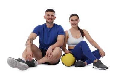 Photo of Woman and man with medicine ball on white background