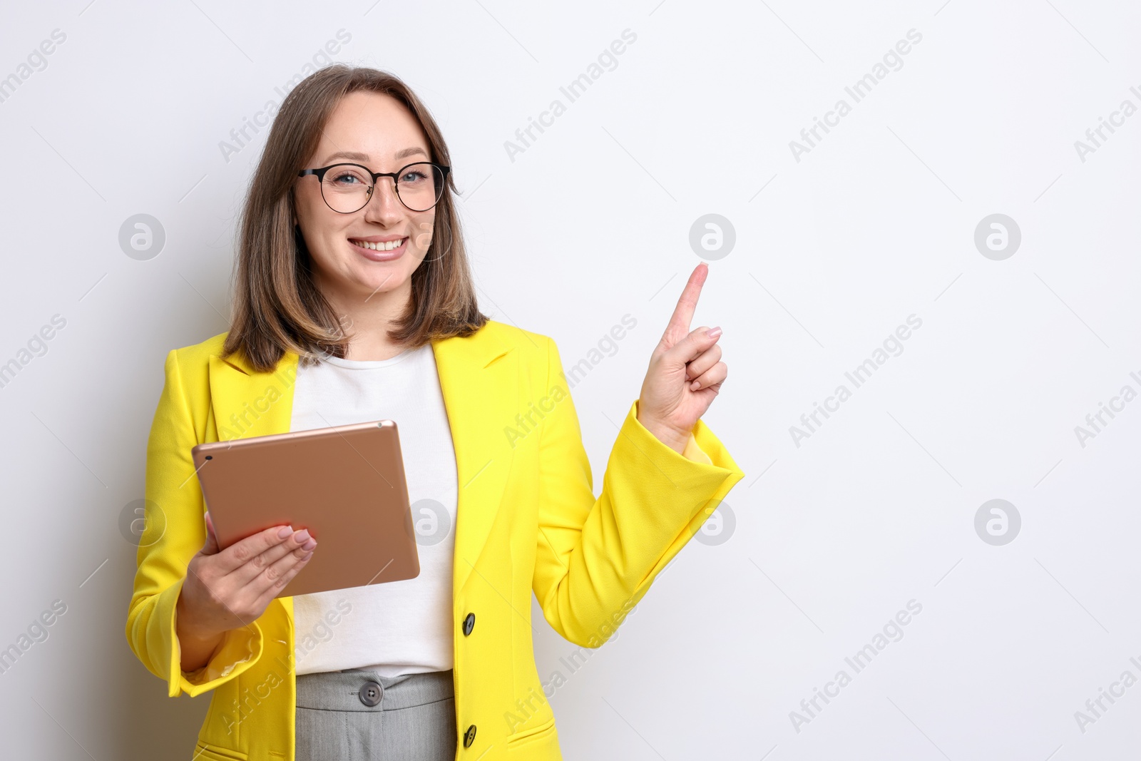 Woman with modern tablet on white background, space for text Photo of Woman with modern tablet on white background, space for text