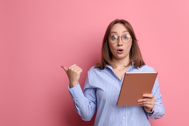 Photo of Woman with modern tablet on pink background, space for text