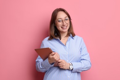 Photo of Woman with modern tablet on pink background