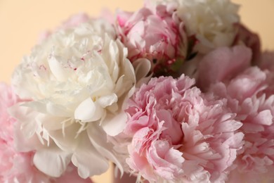 Photo of Bouquet of beautiful peonies on beige background, closeup